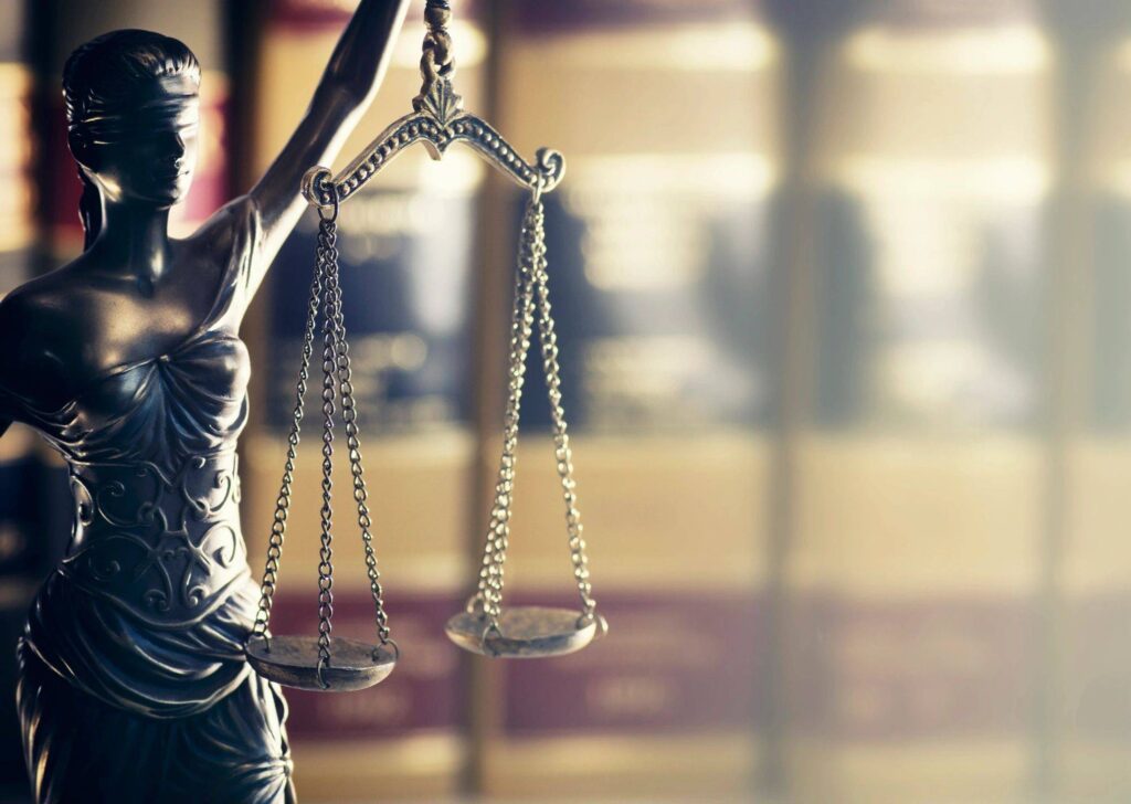 Blindfolded Lady Justice statue with scales